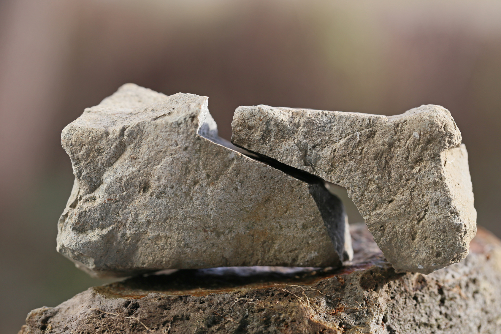 A large rock split apart with a clean fracture